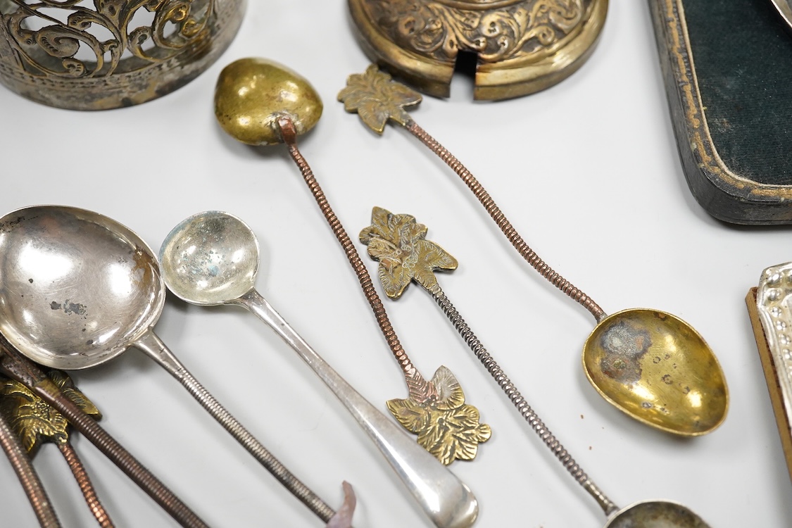 A collection of silver and white metal items, to include a cigarette box, a/f, a German dwarf candlestick, a cased spoon and pusher, etc.